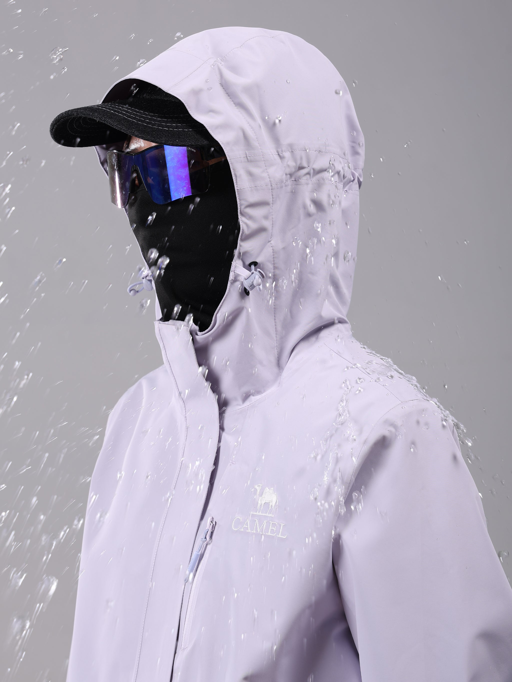 Hood of Camel Women’s Interstellar Traverse Lightweight Shell Jacket, built for outdoor use with waterproof fabric